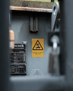a metal box with a warning sign on it