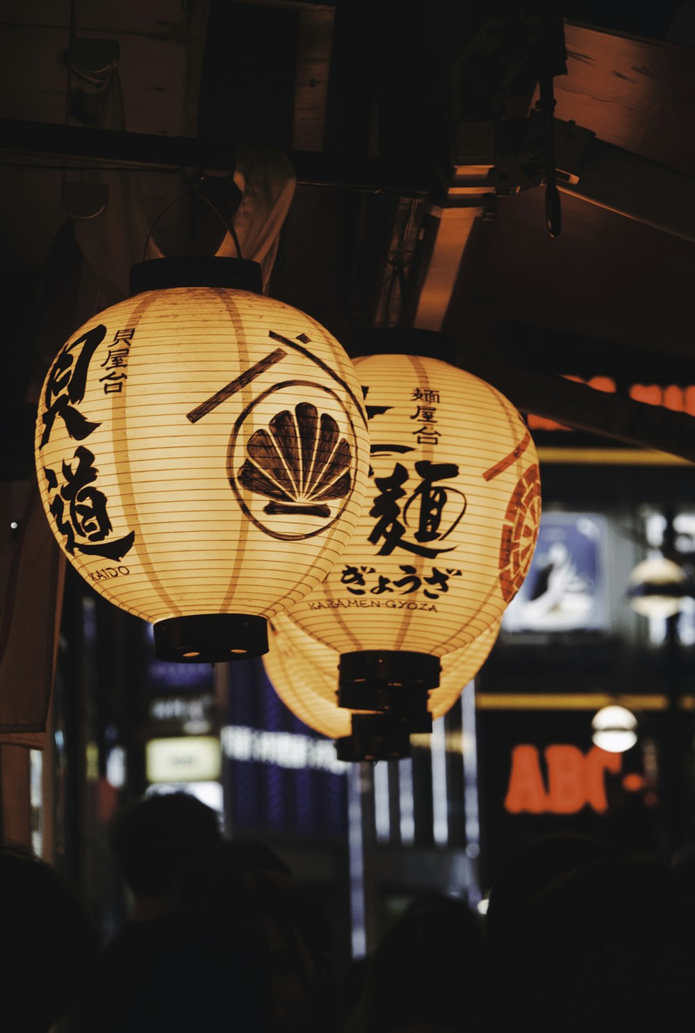 a couple of paper lanterns hanging from a ceiling