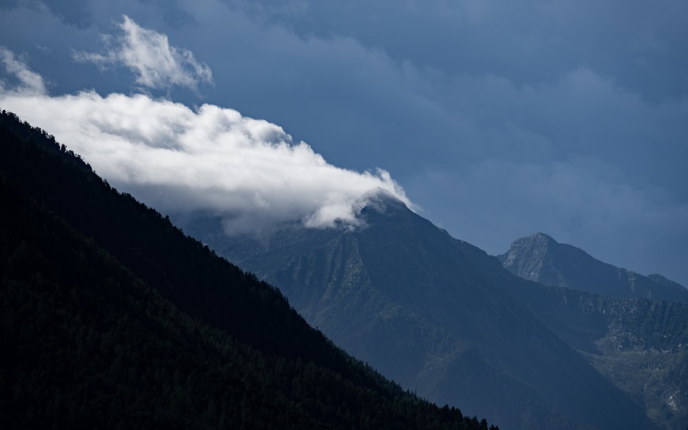 a large mountain with a cloud in the sky