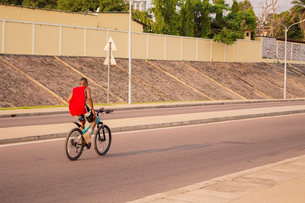 a man riding a bike down a street