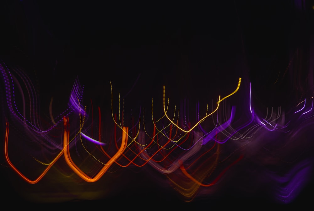 a blurry photo of a black background with colorful lights