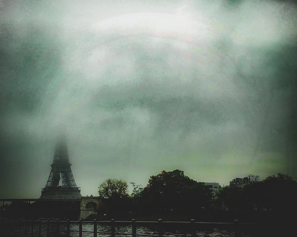 a picture of the eiffel tower with a rainbow in the background