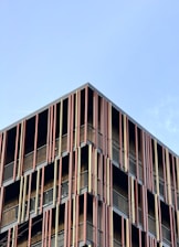 a very tall building with lots of balconies on it