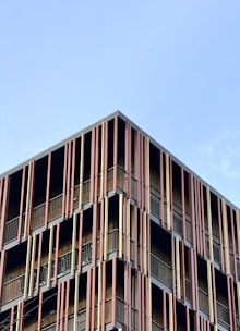 a very tall building with lots of balconies on it