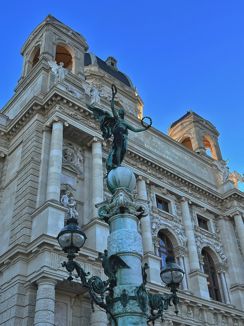 a tall building with a statue on top of it