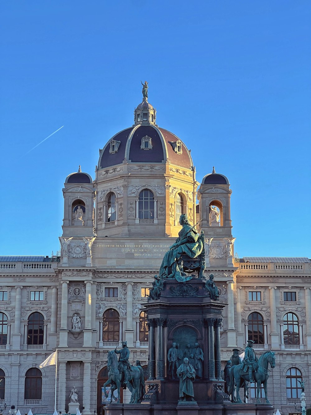 a large building with a statue in front of it