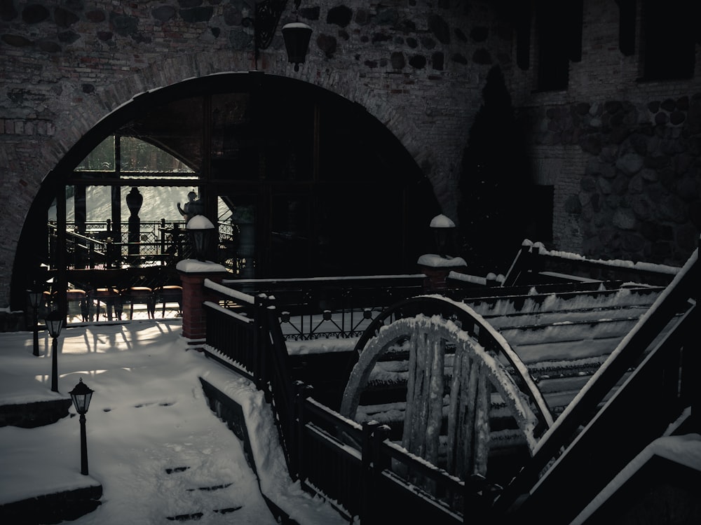 a snow covered walkway leading to a restaurant