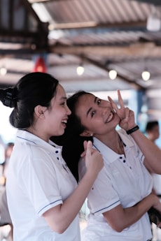 two women in white uniforms standing next to each other