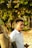 a man standing next to a tree in a forest