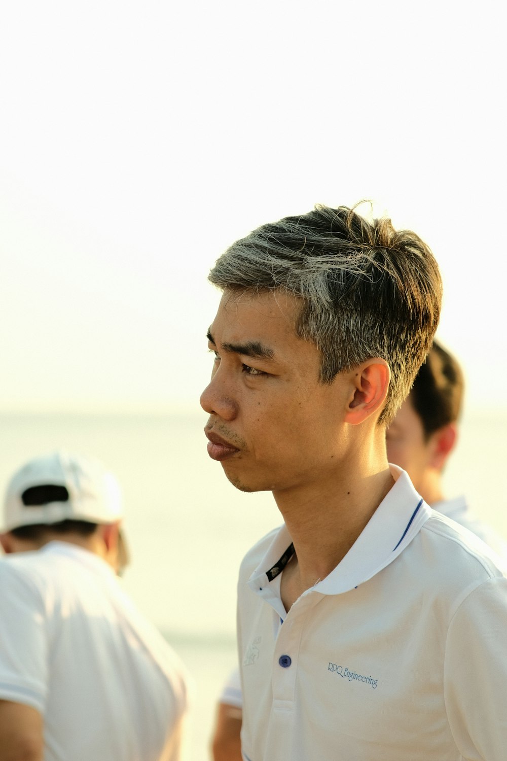 a man standing on a beach next to the ocean