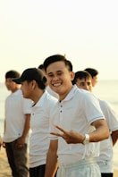 a group of men standing next to each other on a beach