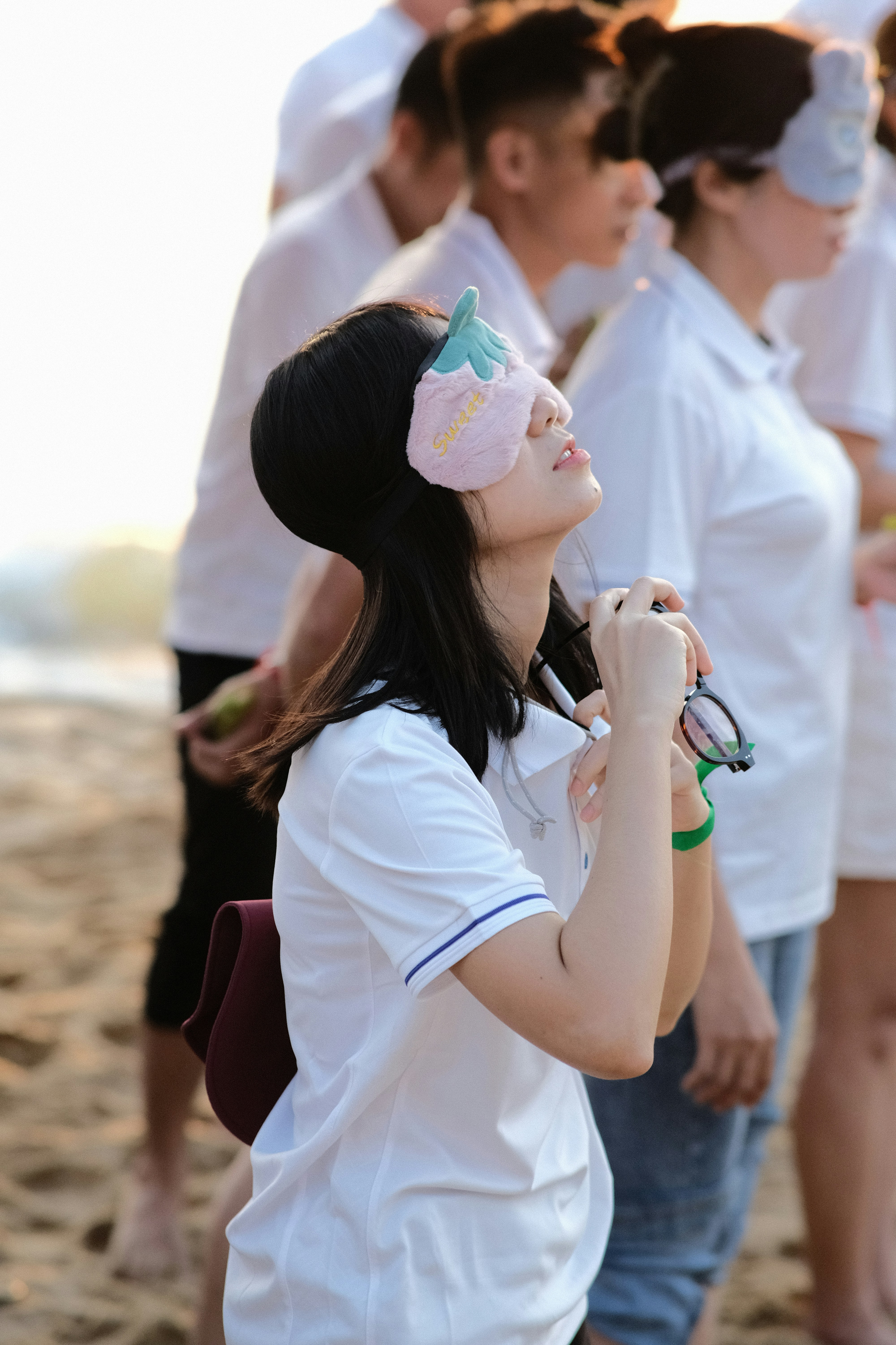 a group of women standing on top of a sandy beach