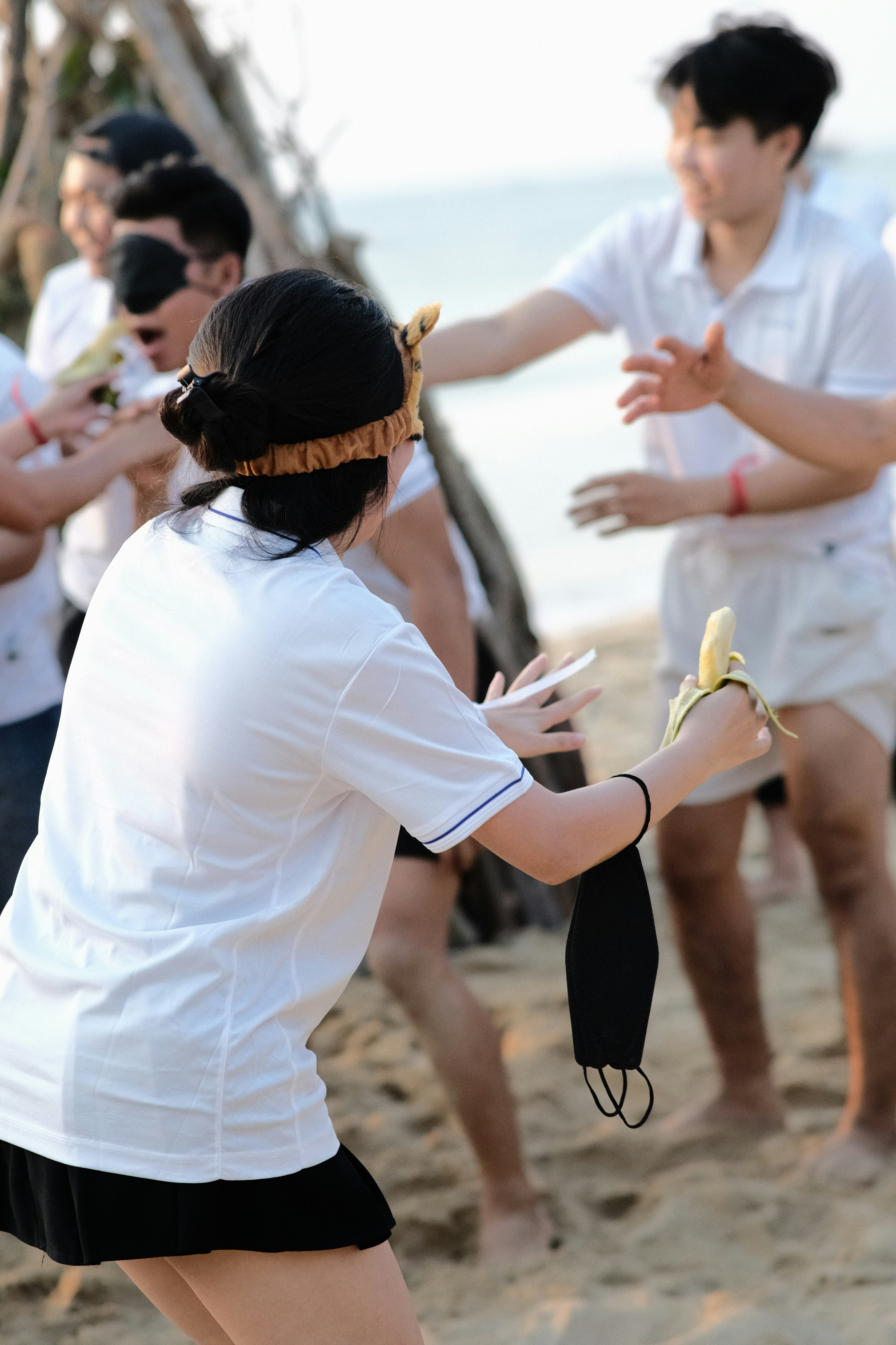 a group of people standing on top of a sandy beach