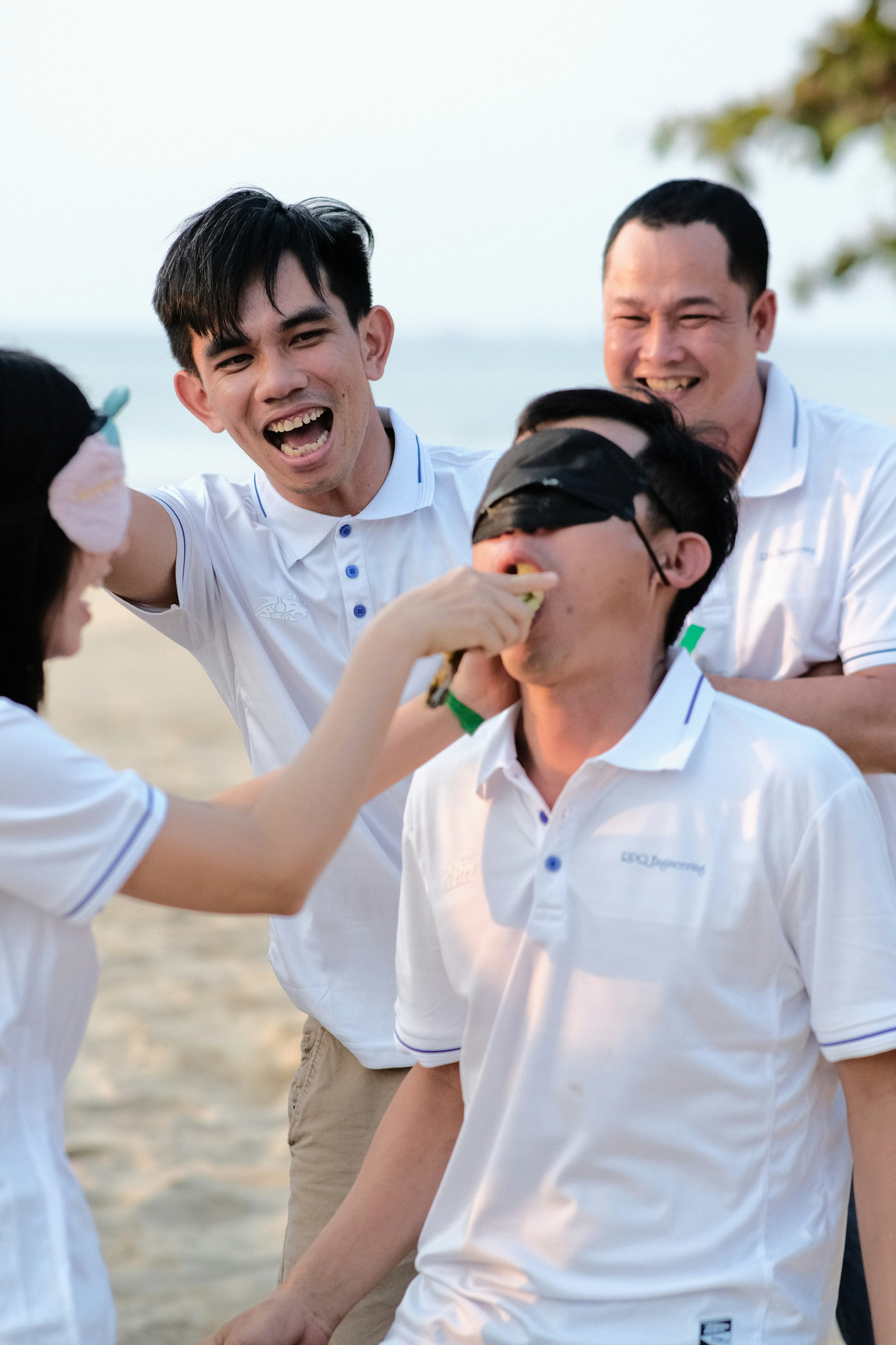 a group of people standing on top of a beach