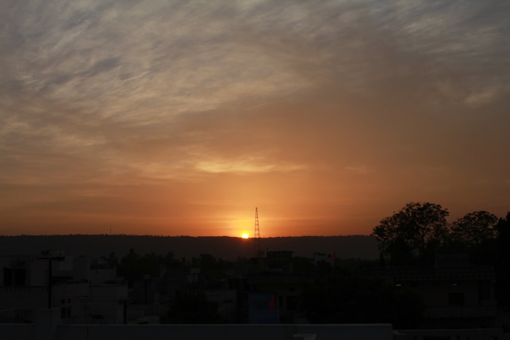 the sun is setting over a city skyline