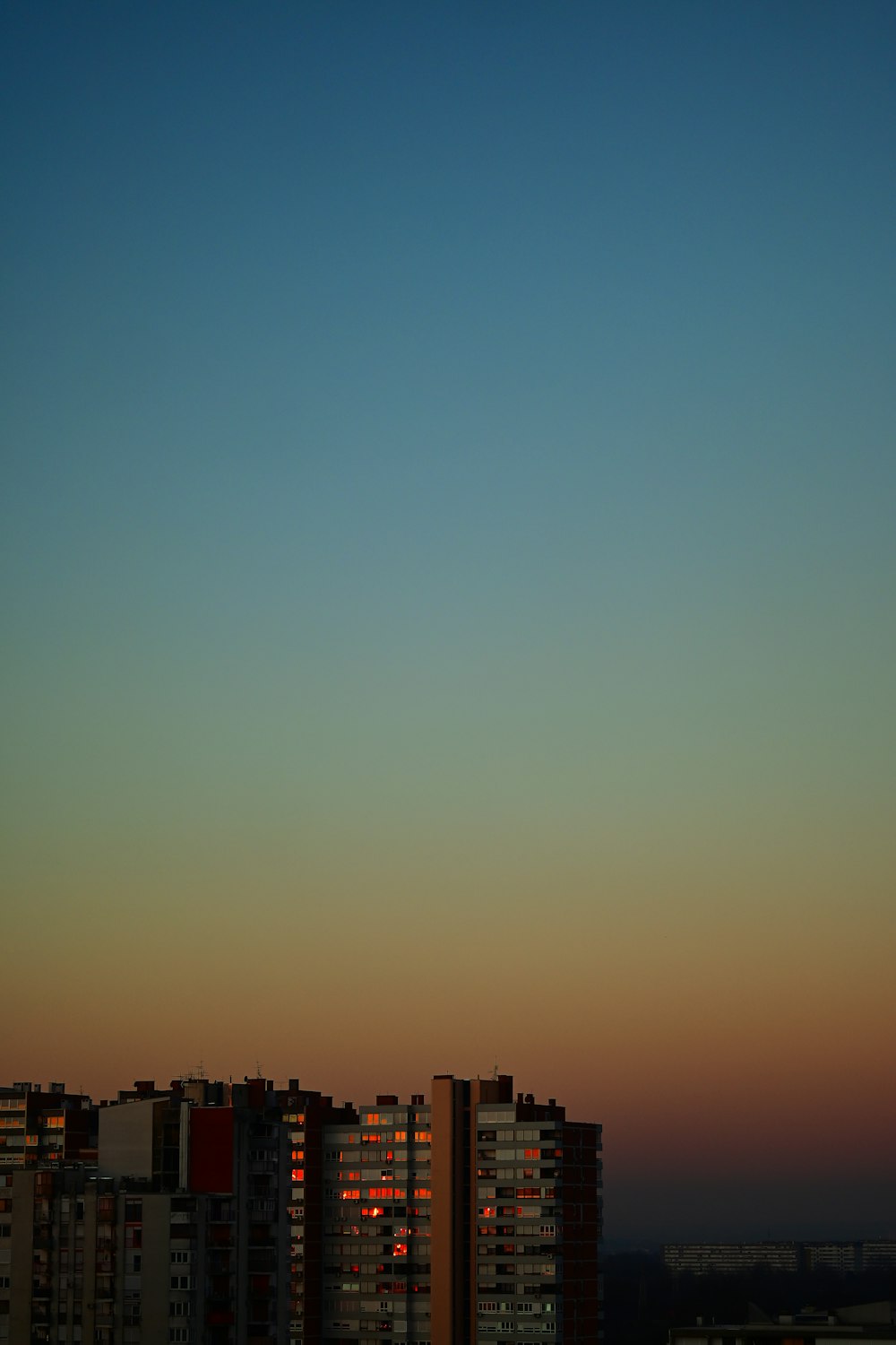 a plane flying in the sky over a city