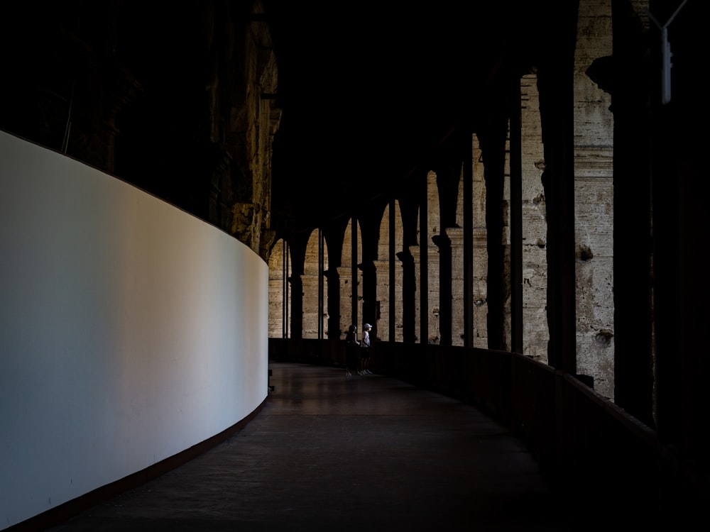 a person is standing on a bridge in the dark