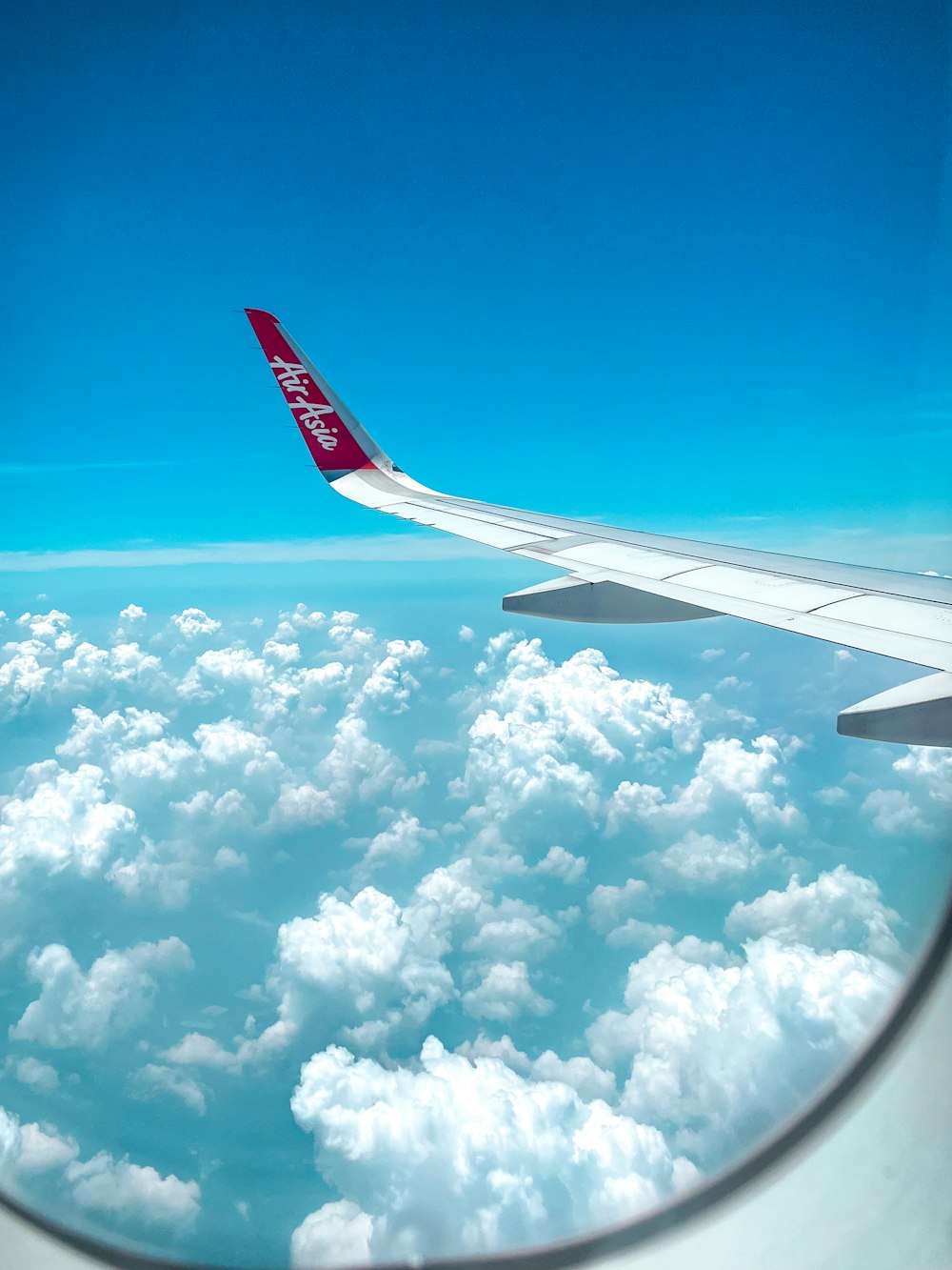 the wing of an airplane flying above the clouds