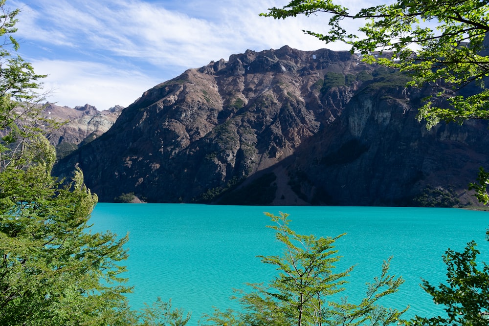 a blue lake surrounded by mountains and trees