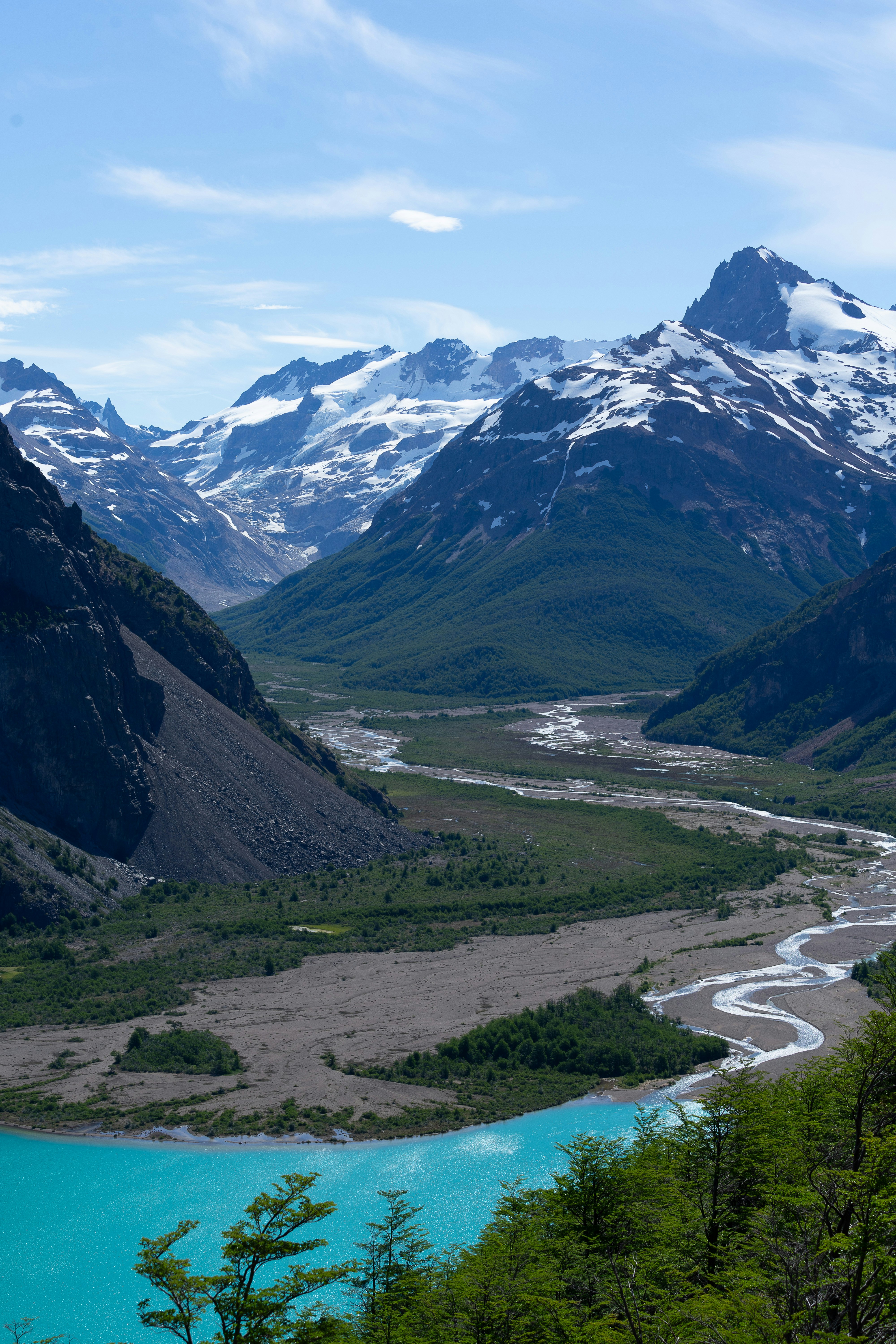 a river running through a valley surrounded by mountains