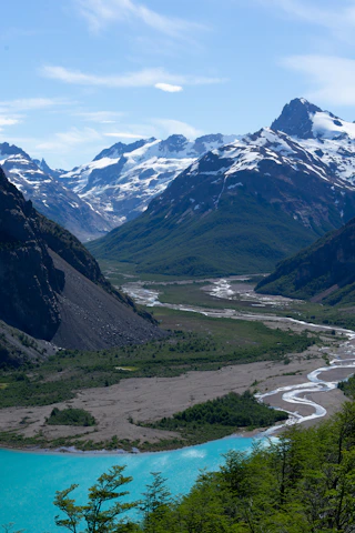 a river running through a valley surrounded by mountains