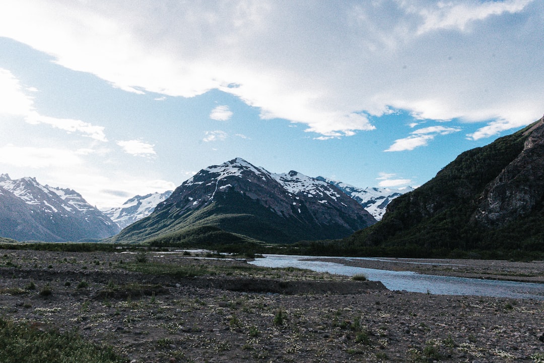 a river running through a lush green valley, 