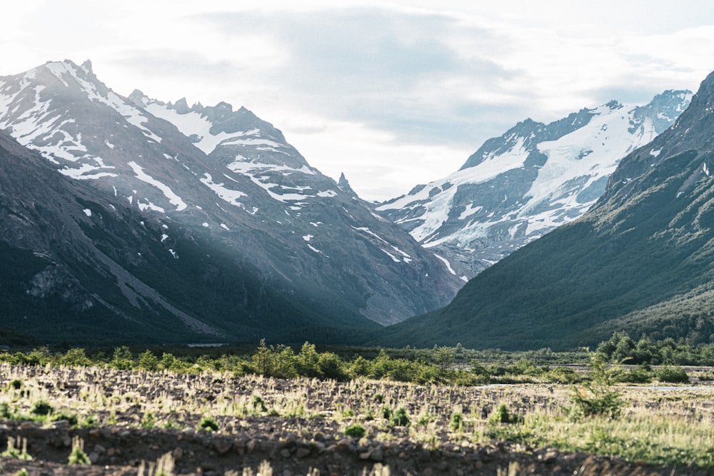 a mountain range with snow covered mountains in the background