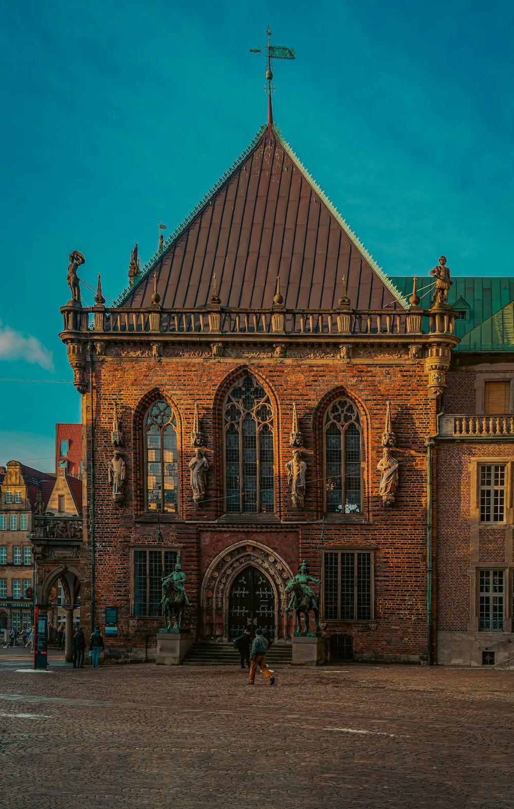 a large brick building with a green roof