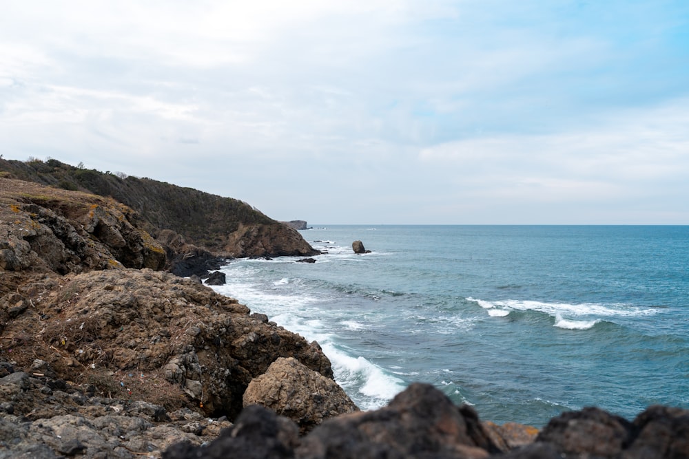 a view of the ocean from a rocky cliff