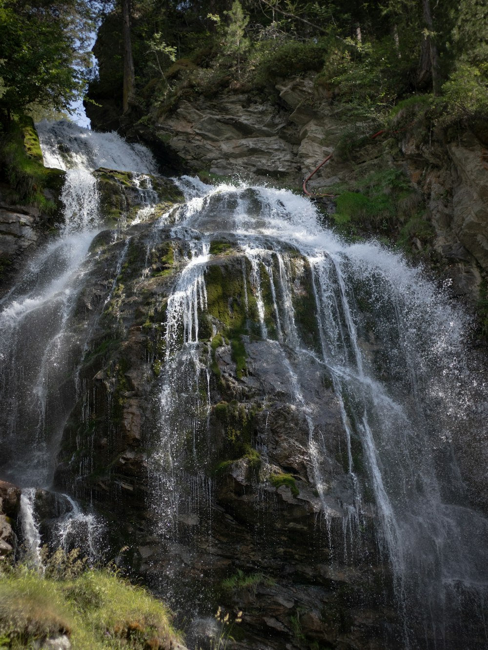 a large waterfall in the middle of a forest