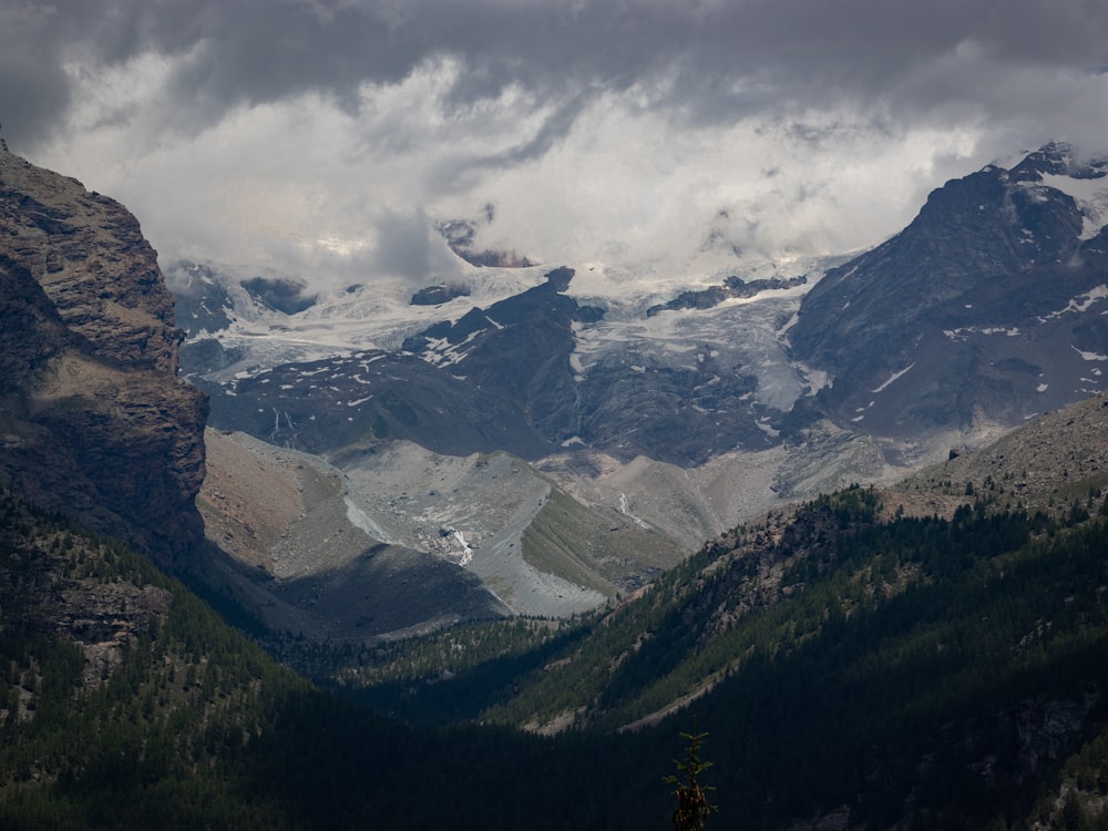 a view of a mountain range with snow on it