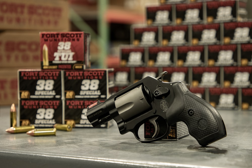 a gun and some cartridges on a table