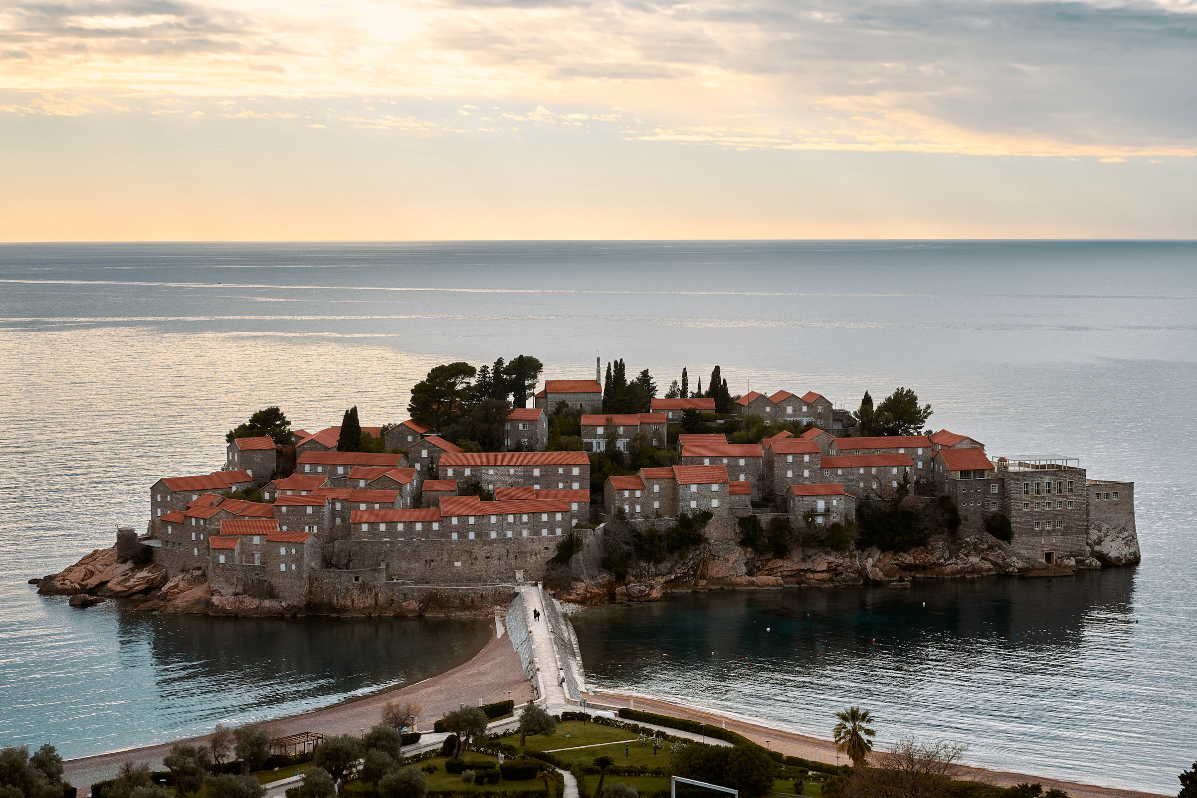 The island village of Sveti Stefan in Montenegro in soft golden evening light