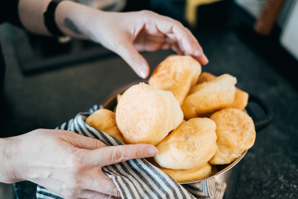 a person reaching for some food in a bowl