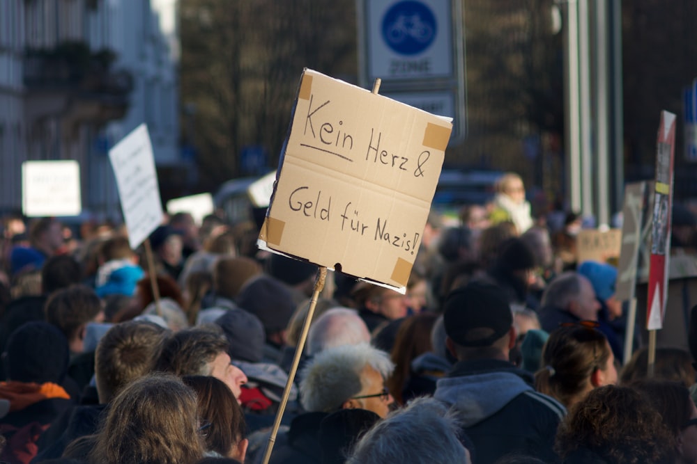 a crowd of people holding signs and placards