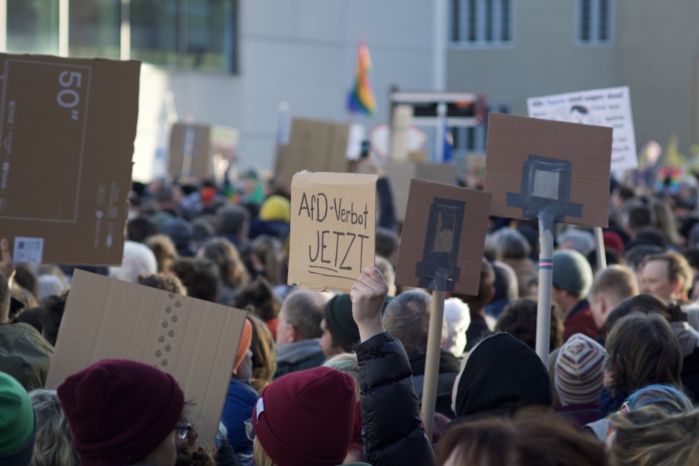 a large group of people holding up signs