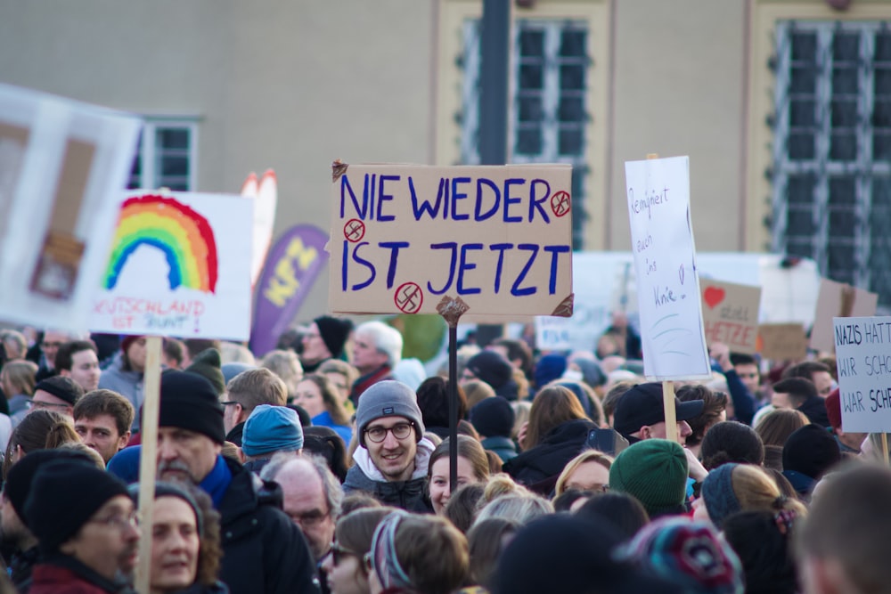 a large group of people holding up signs