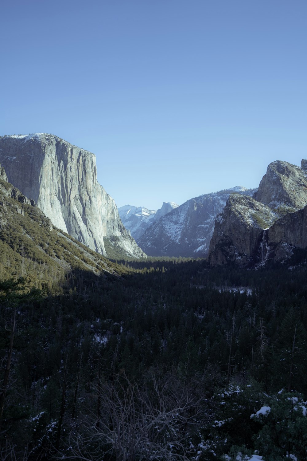 a view of a valley with mountains in the background