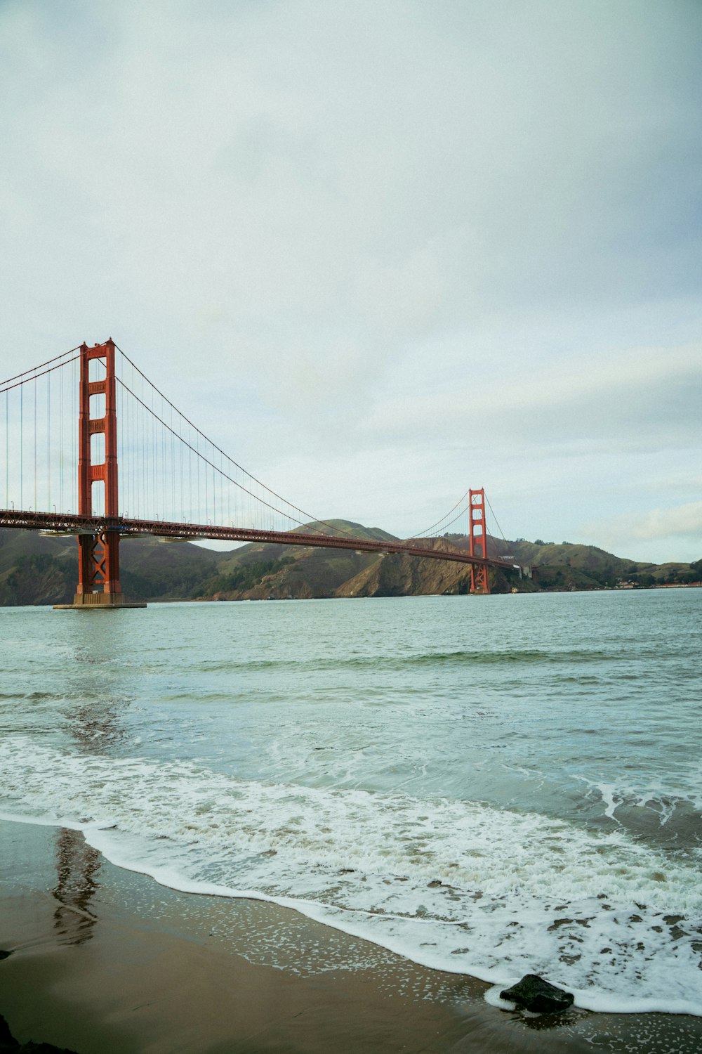 a view of the golden gate bridge from the beach