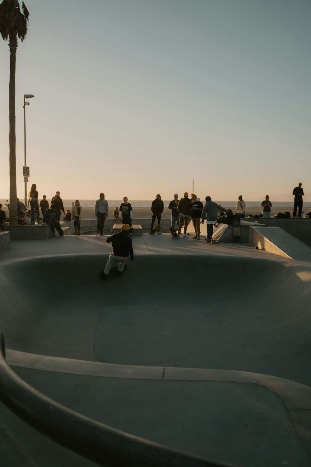 a group of people standing around a skate park