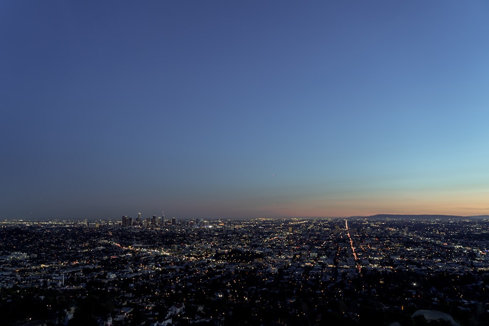 a view of a city at night from the top of a hill