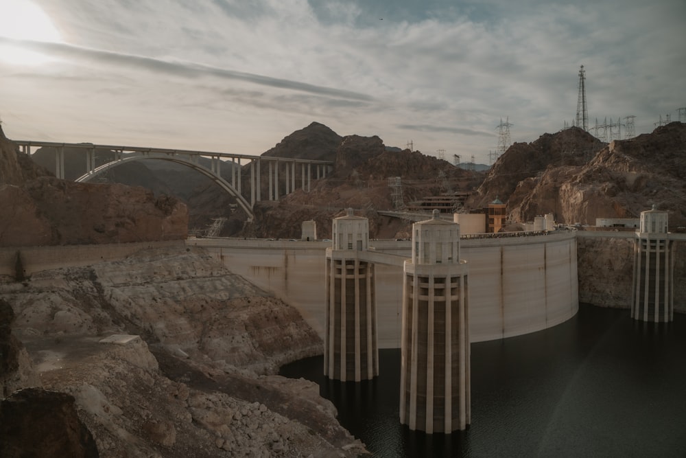 a large dam with a bridge in the background