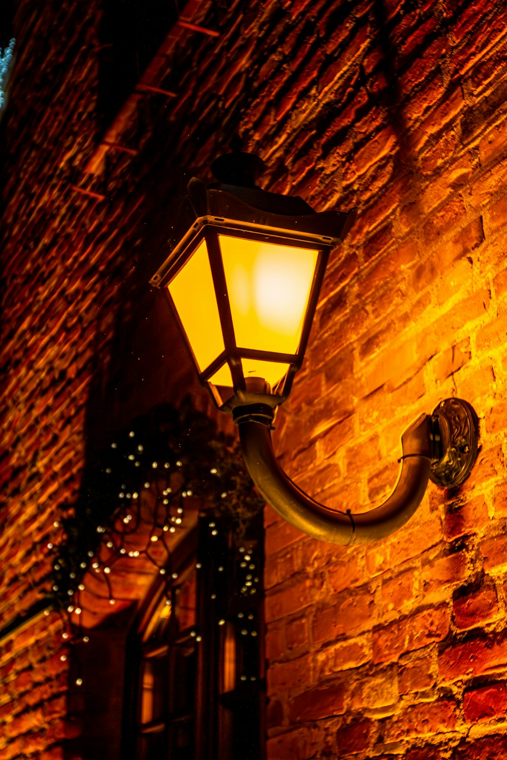 a street light on a brick building at night