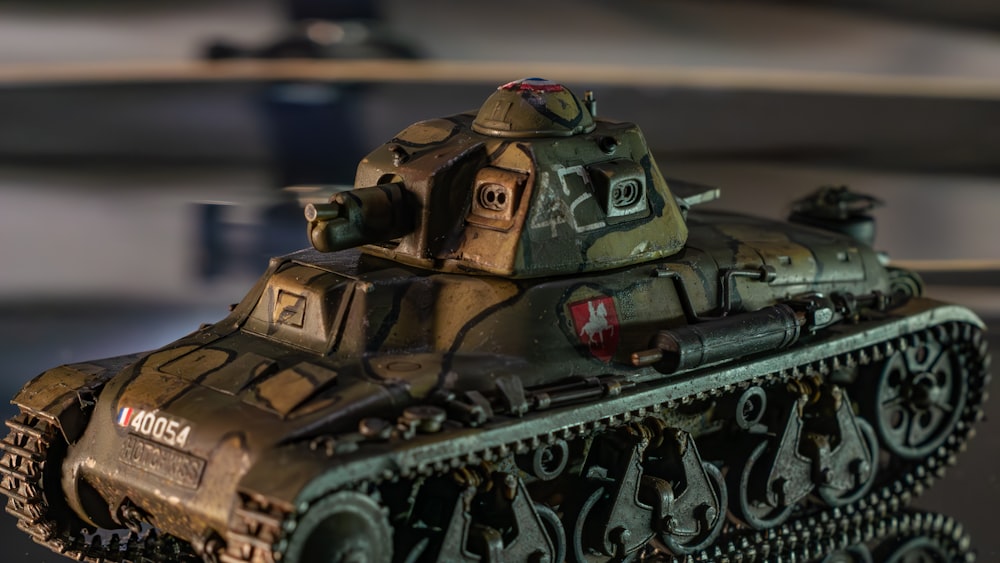 a close up of a toy tank on a table