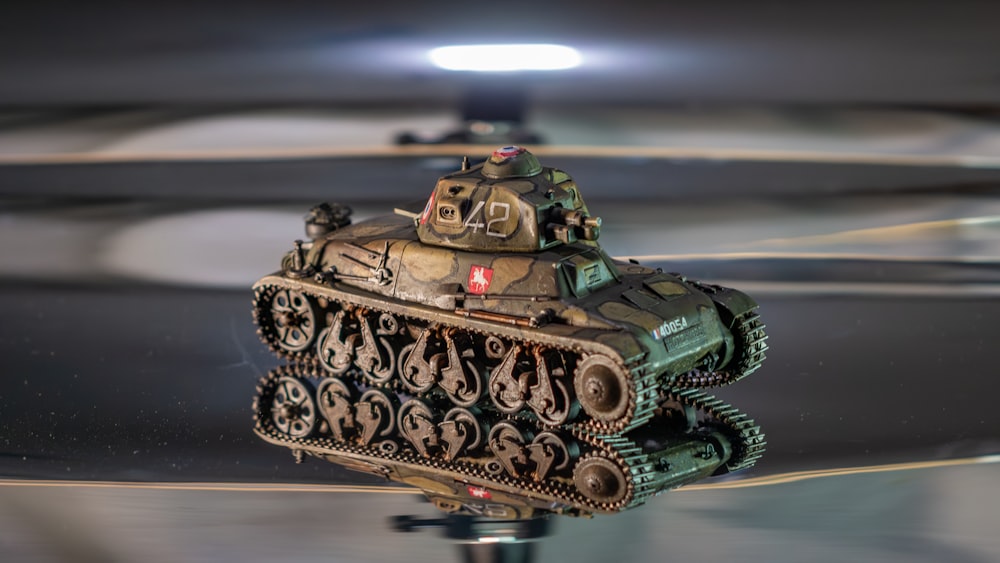 a close up of a toy tank on a table