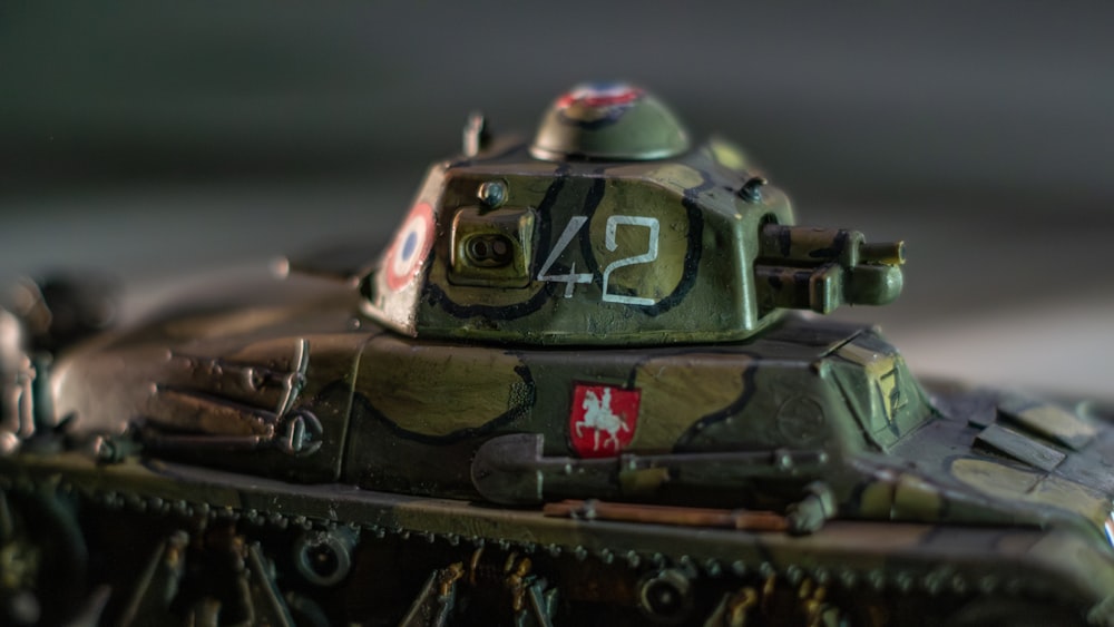 a close up of a toy tank on a table