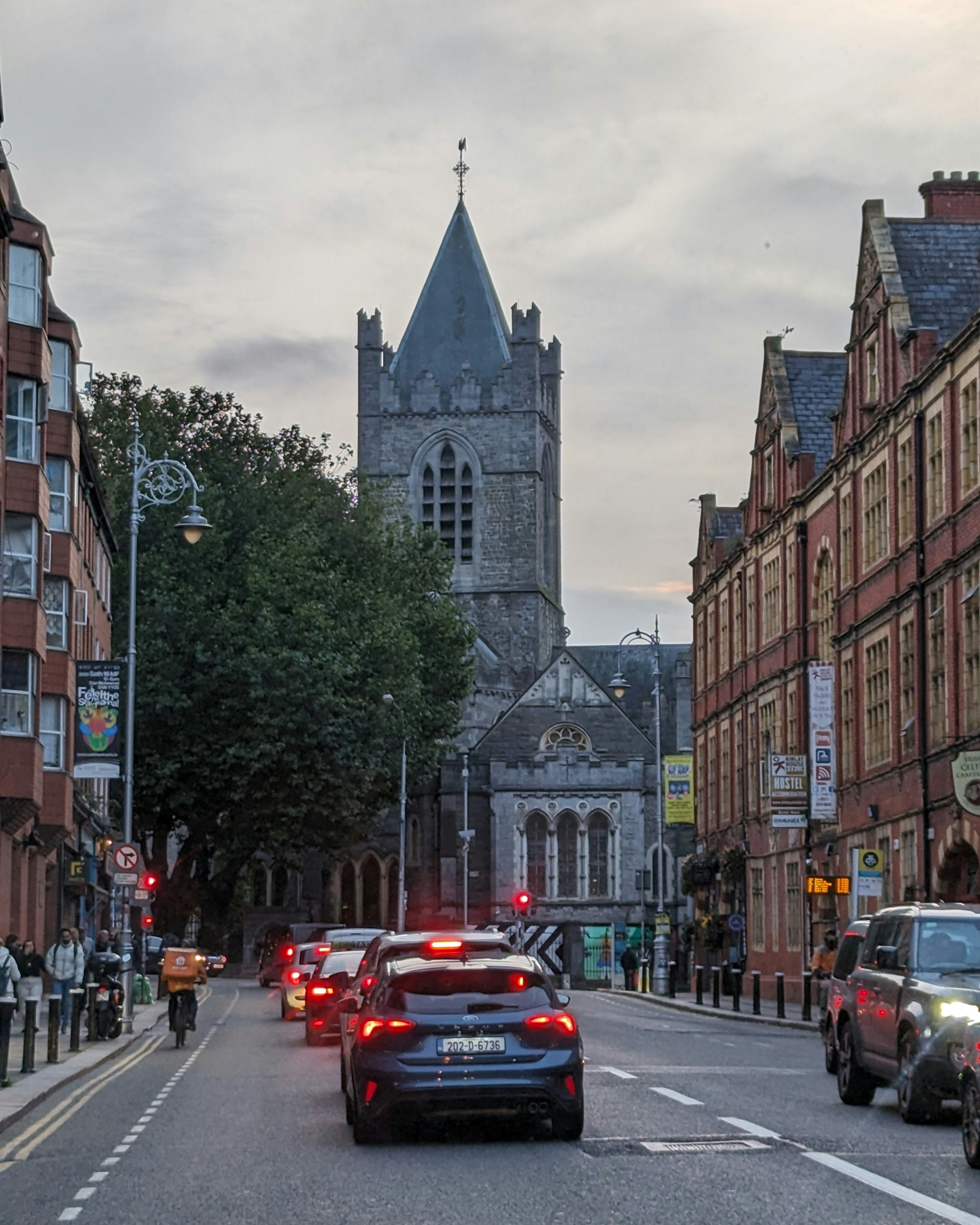 a city street filled with traffic next to tall buildings