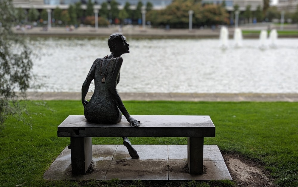 a statue of a person sitting on a bench