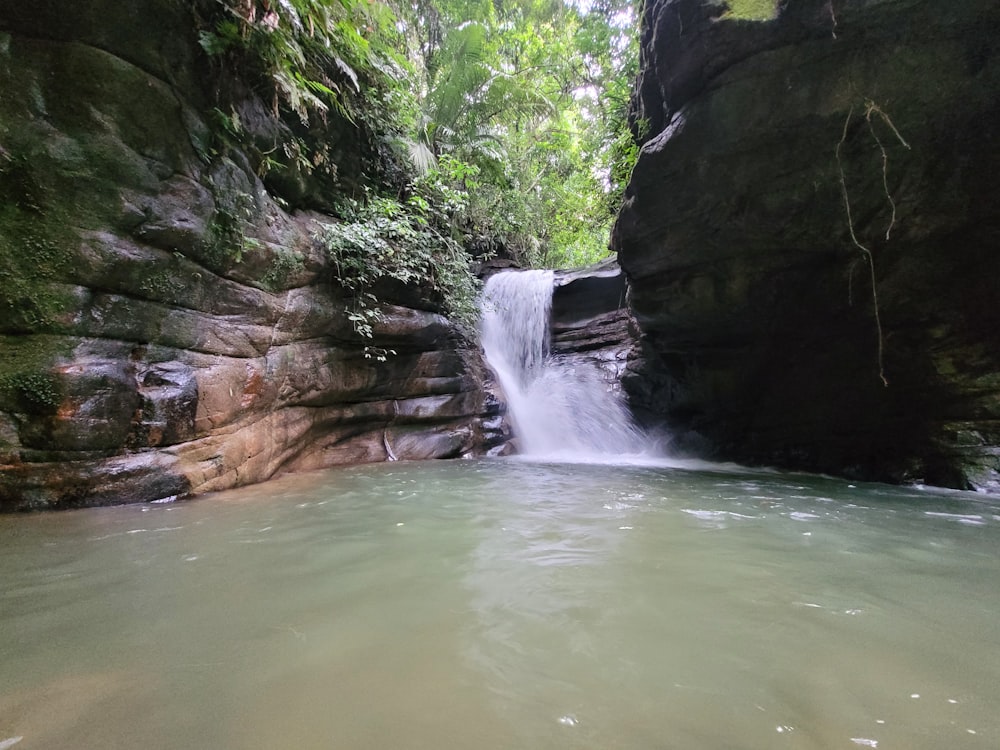 a small waterfall in the middle of a river