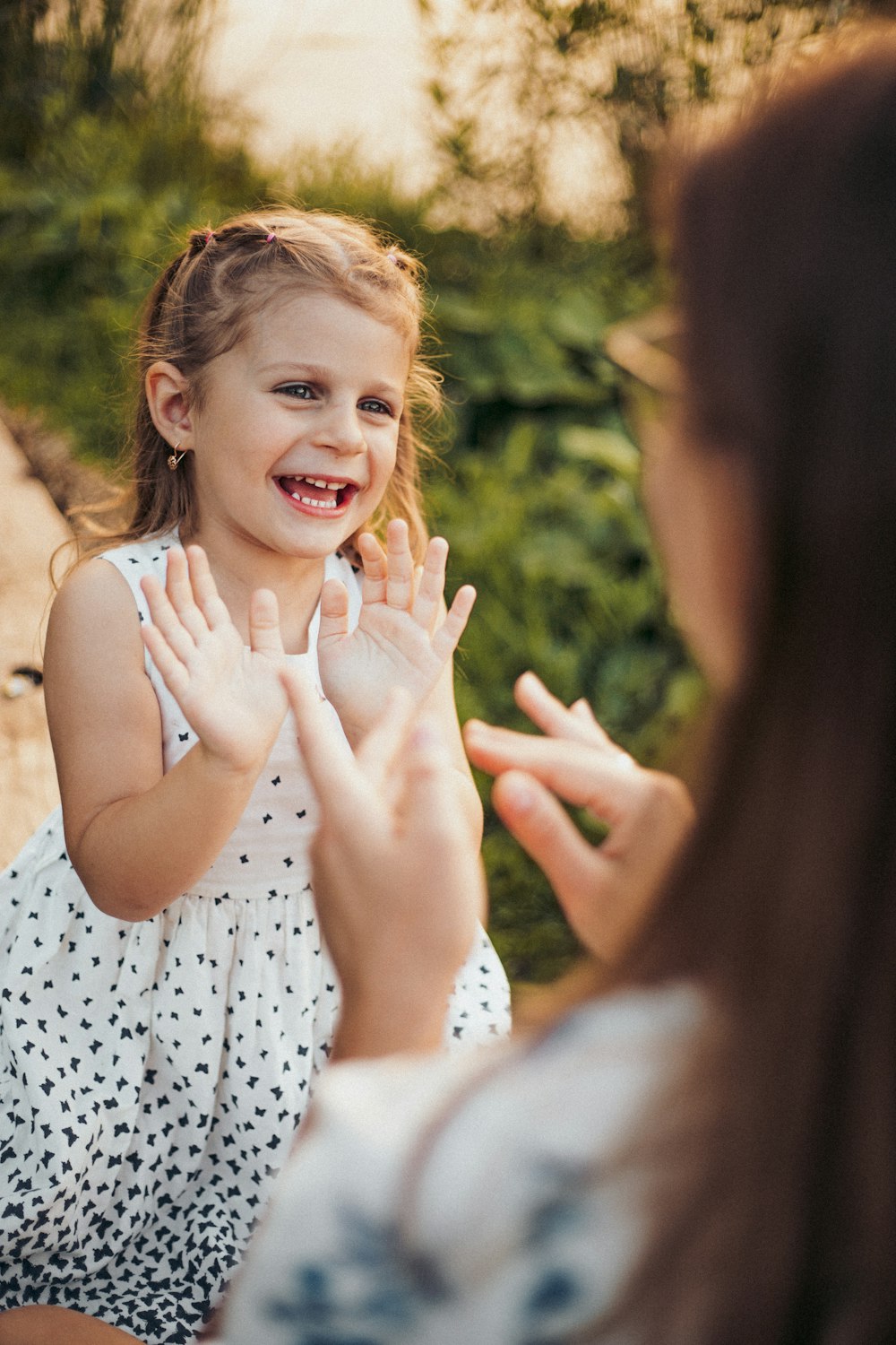 a little girl is smiling and clapping her hands